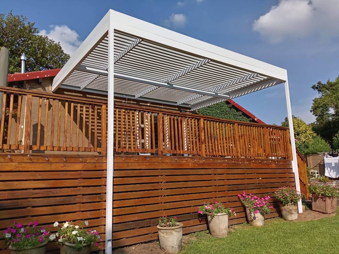 White adjustable louvre with the blades open over a raised timber deck in Morningside